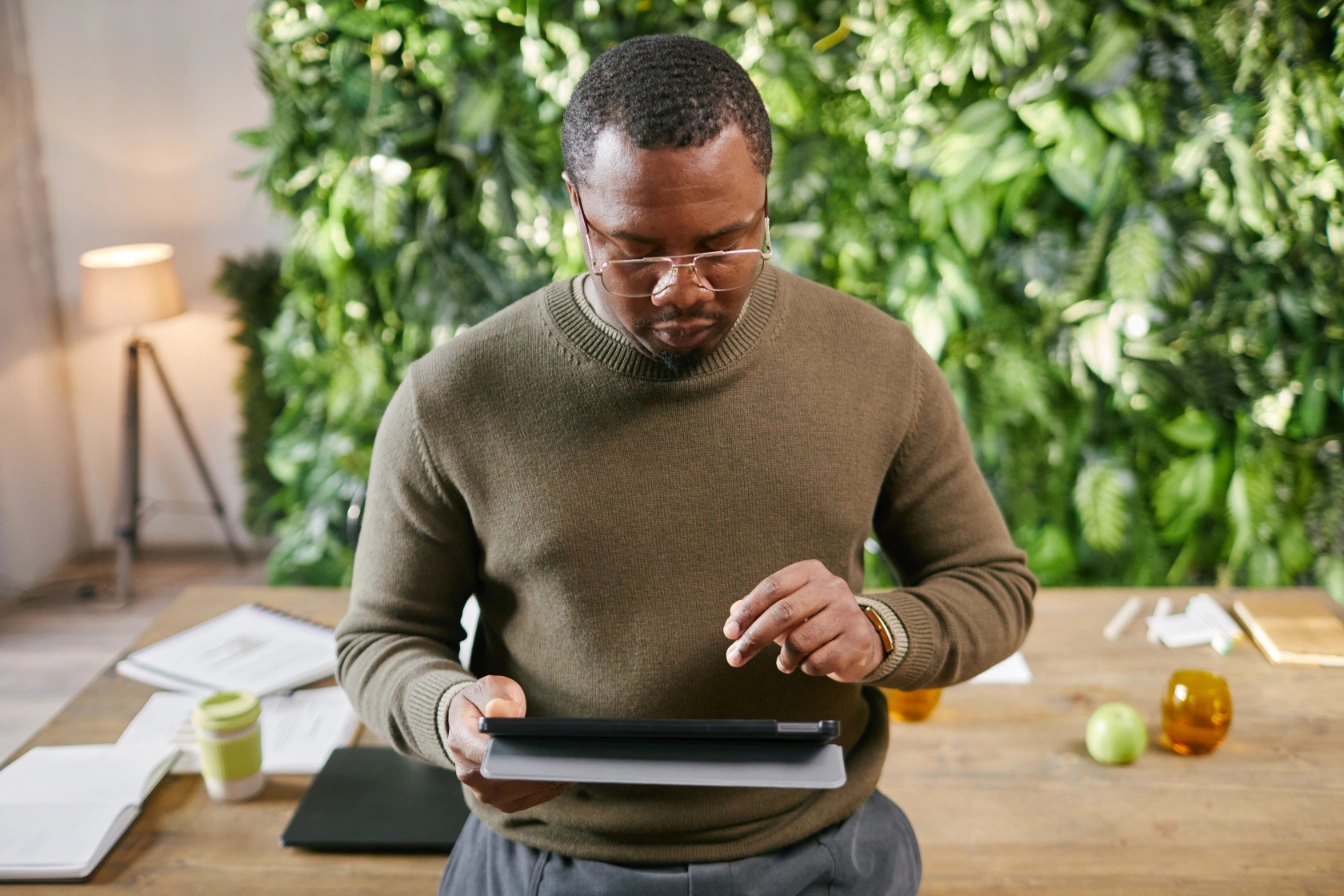 middle-aged-black-man-using-digital-tablet-while-w-2025-07-17-18-57-29-utc